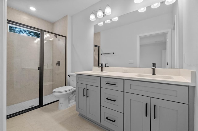 bathroom with tile patterned flooring, vanity, an enclosed shower, and toilet