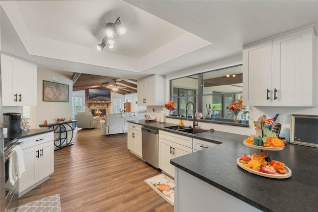 kitchen featuring dark hardwood / wood-style flooring, white cabinetry, sink, and stainless steel appliances