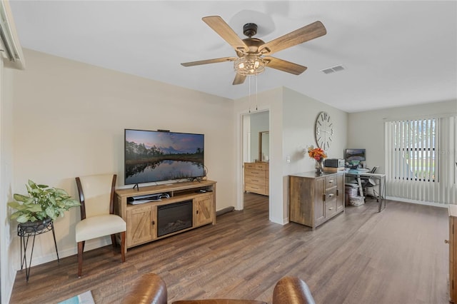 living room featuring ceiling fan and dark hardwood / wood-style flooring