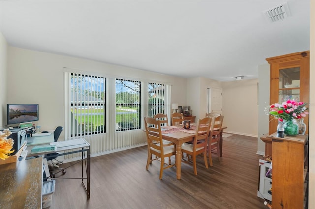 dining area featuring dark wood-type flooring