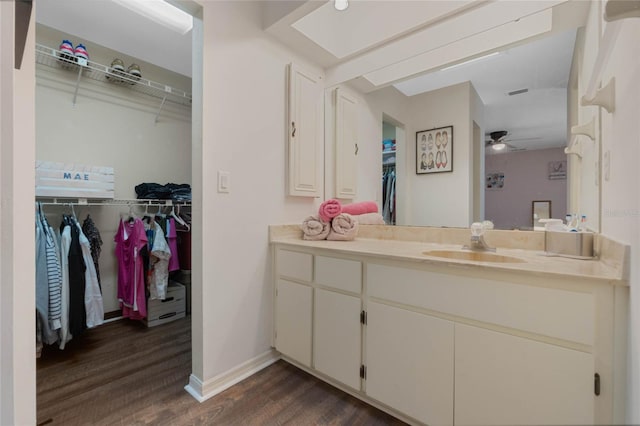 bathroom featuring hardwood / wood-style floors, ceiling fan, and vanity