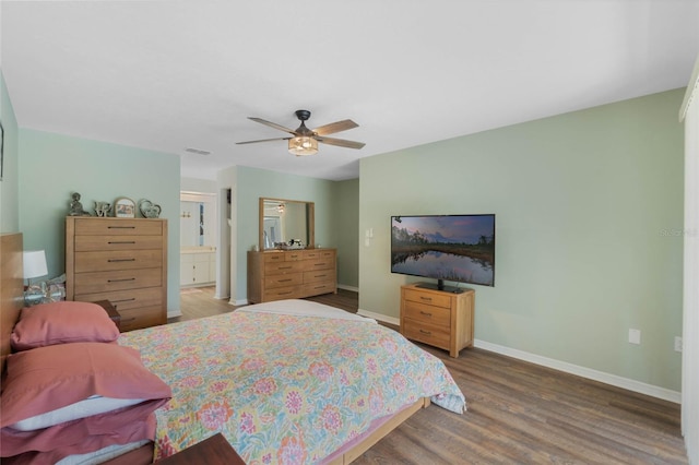 bedroom with connected bathroom, wood-type flooring, and ceiling fan