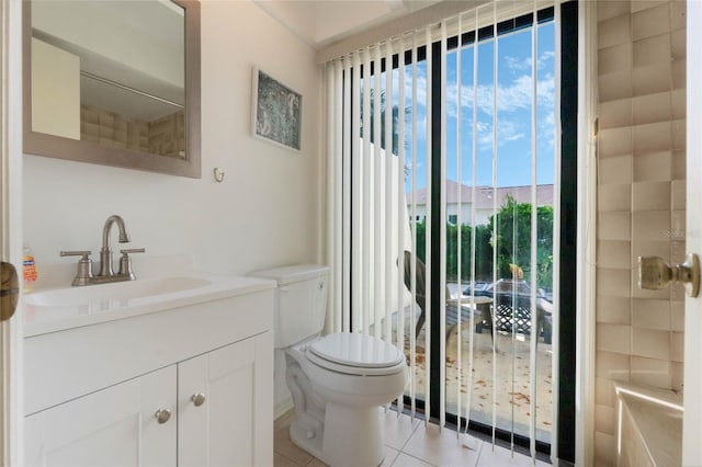 bathroom with vanity, tile patterned flooring, and toilet