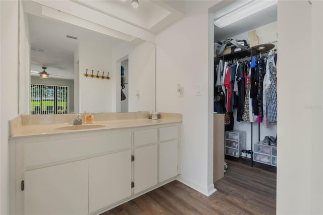 bathroom with hardwood / wood-style floors, ceiling fan, and vanity