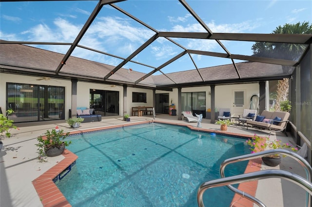 view of swimming pool featuring a lanai, ceiling fan, an outdoor living space, and a patio area