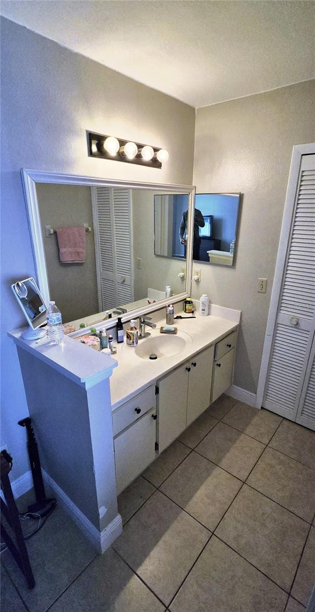 bathroom with tile patterned flooring and vanity