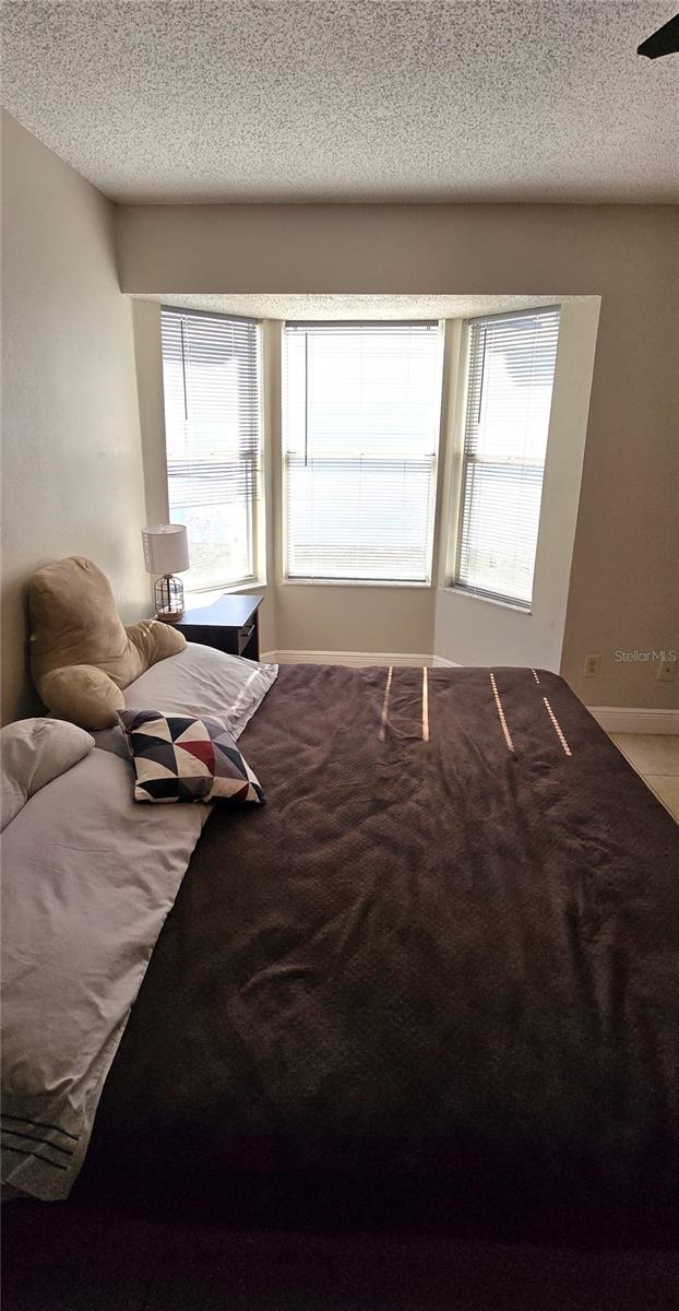 bedroom with carpet and a textured ceiling