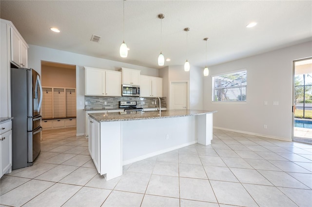 kitchen with white cabinetry, plenty of natural light, hanging light fixtures, and appliances with stainless steel finishes