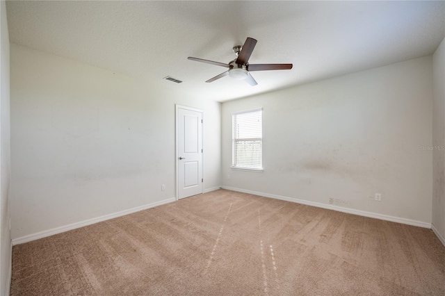 unfurnished room with ceiling fan and light colored carpet