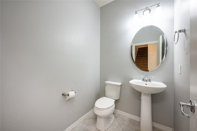 bathroom with tile patterned floors, toilet, and sink