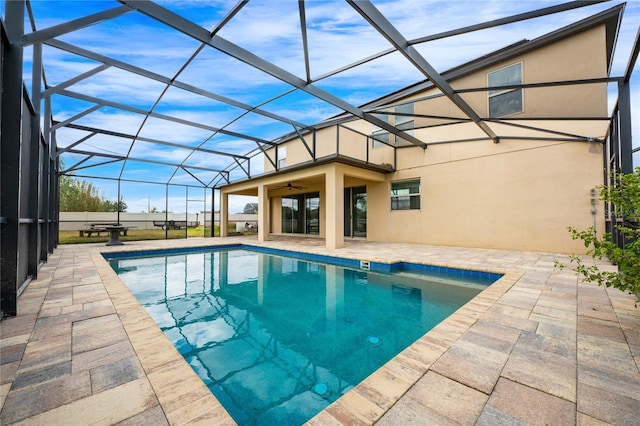 view of pool featuring a patio, ceiling fan, and a lanai