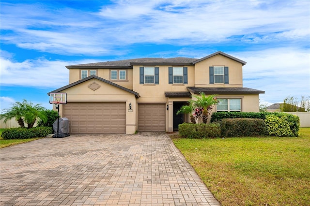 view of front of home with a front lawn and a garage