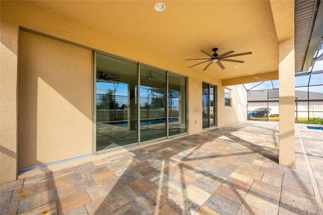 view of patio / terrace with a lanai and ceiling fan