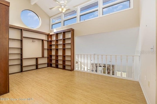 interior space featuring beamed ceiling, ceiling fan, light wood-type flooring, and high vaulted ceiling