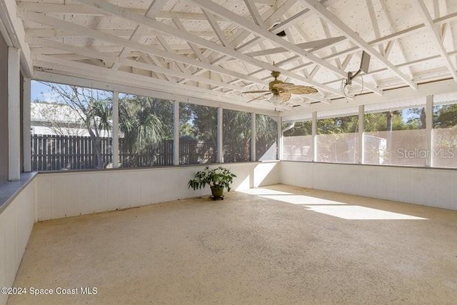 unfurnished sunroom featuring ceiling fan