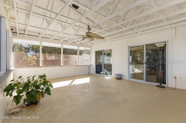 unfurnished sunroom with ceiling fan