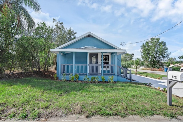 bungalow-style home featuring a porch and a front lawn