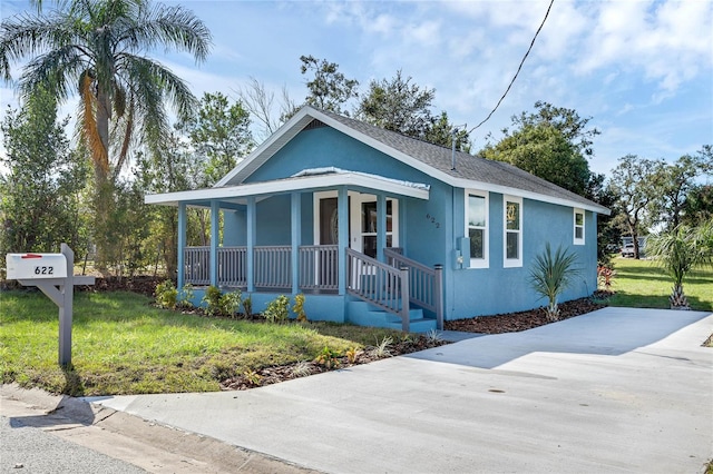 view of front of home with a front yard and a porch