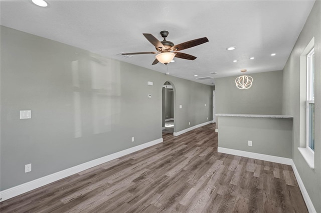 empty room with hardwood / wood-style floors and ceiling fan