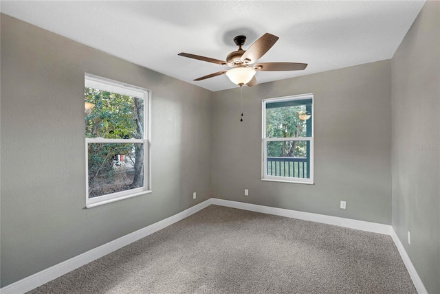 carpeted empty room featuring ceiling fan