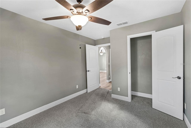 unfurnished bedroom with ceiling fan, a closet, and carpet floors