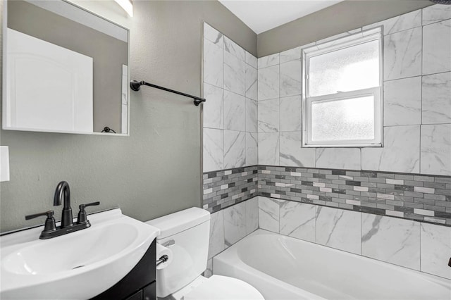 full bathroom with vanity, toilet, and tiled shower / bath combo