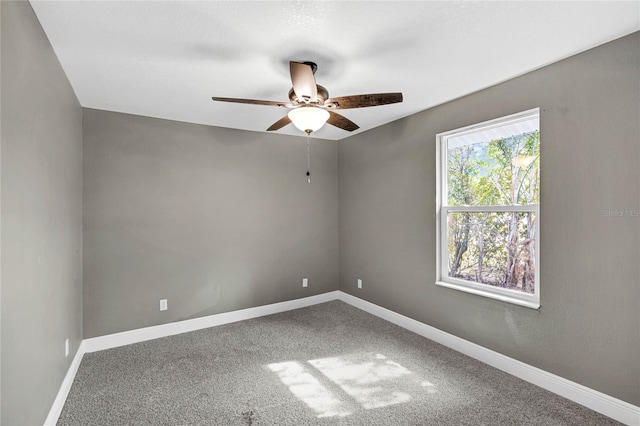 unfurnished room with ceiling fan and carpet floors