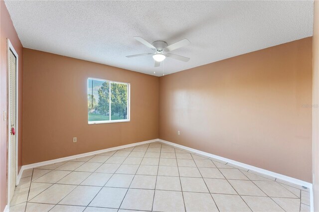 5208 Via Hacienda Cir Unit 201, Orlando, FL 32839 - empty room with a ceiling fan, a textured ceiling, and baseboards