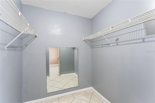 spacious closet featuring light tile patterned flooring