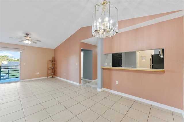 empty room with ceiling fan with notable chandelier, lofted ceiling, and tile patterned floors