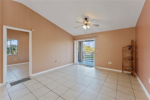 spare room featuring ceiling fan, vaulted ceiling, and light tile patterned flooring