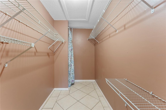 spacious closet featuring tile patterned floors