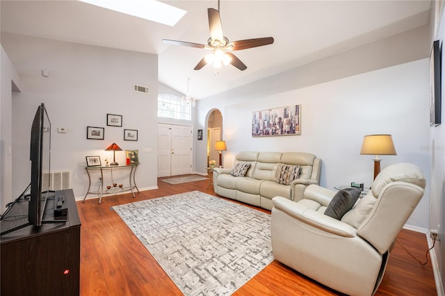 living room featuring ceiling fan, wood-type flooring, and lofted ceiling