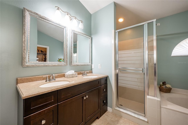 bathroom featuring tile patterned floors, vanity, lofted ceiling, and independent shower and bath