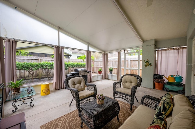 sunroom featuring lofted ceiling