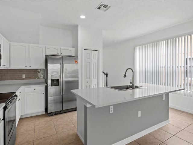 kitchen with a wealth of natural light, sink, stainless steel appliances, and a kitchen island with sink