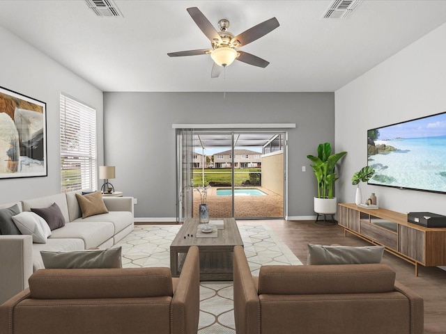 living room with hardwood / wood-style flooring, plenty of natural light, and ceiling fan