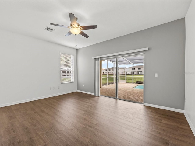 empty room featuring ceiling fan and dark wood-type flooring