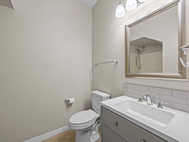 bathroom with tile patterned floors, decorative backsplash, toilet, and vanity