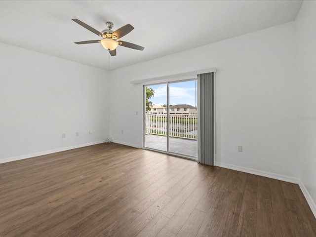 empty room featuring ceiling fan and dark hardwood / wood-style floors