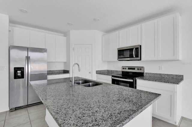 kitchen with sink, white cabinetry, stainless steel appliances, and an island with sink