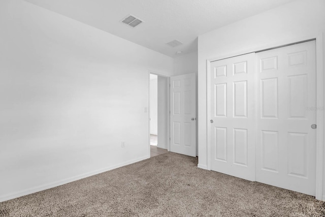 unfurnished bedroom with a closet and carpet floors