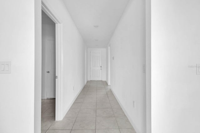 corridor featuring light tile patterned floors