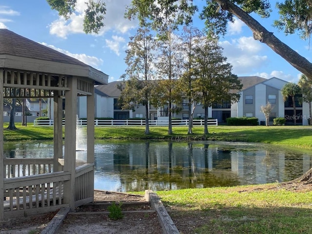 dock area with a water view and a lawn