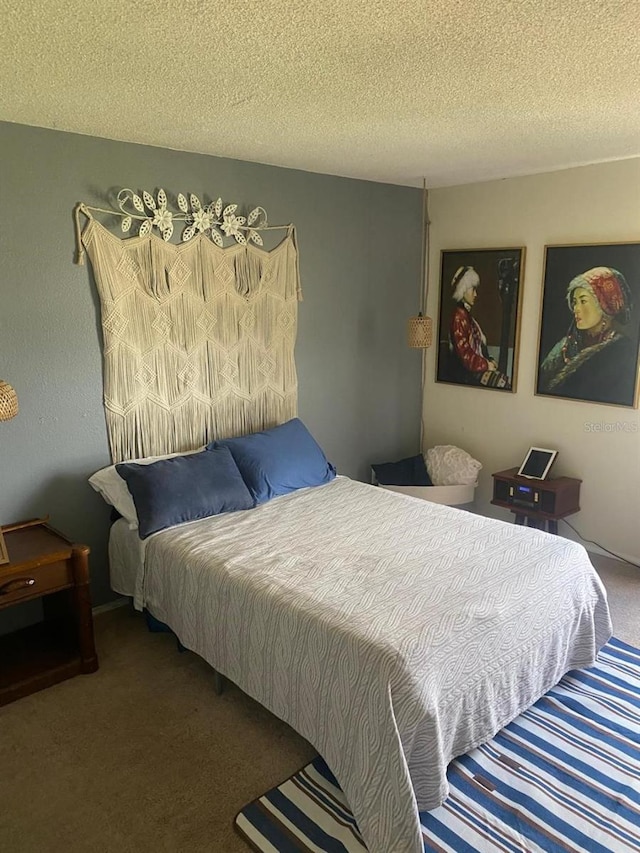 bedroom with carpet flooring and a textured ceiling