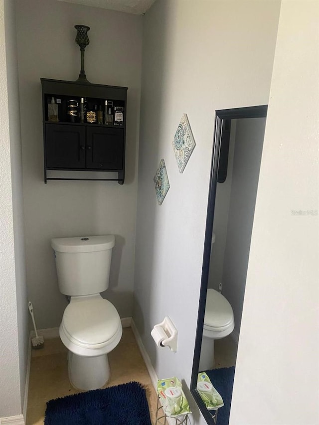 bathroom with tile patterned floors and toilet