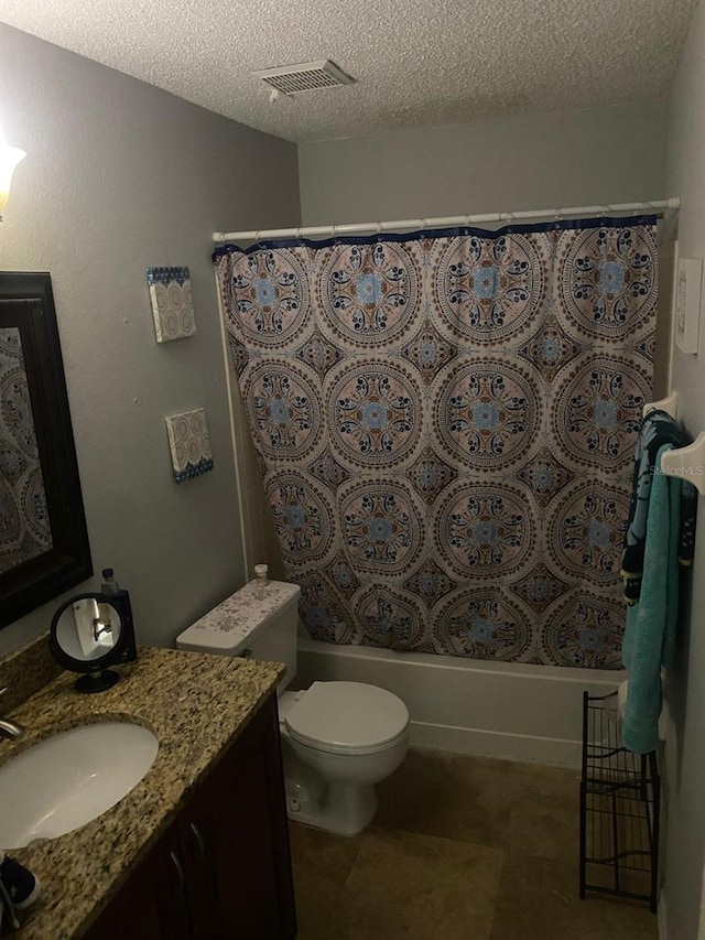 full bathroom with shower / bath combo with shower curtain, vanity, a textured ceiling, and toilet