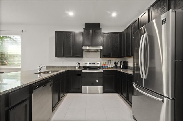 kitchen featuring sink, light tile patterned floors, kitchen peninsula, stainless steel appliances, and light stone counters