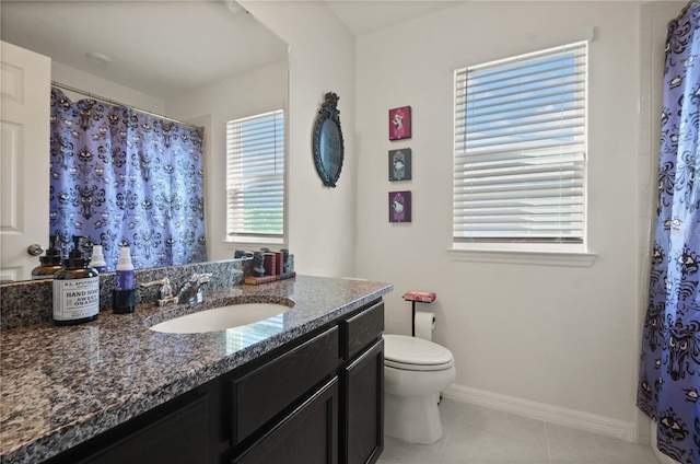 bathroom with toilet, vanity, tile patterned floors, and a shower with shower curtain