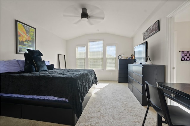 bedroom with light colored carpet, vaulted ceiling, and ceiling fan